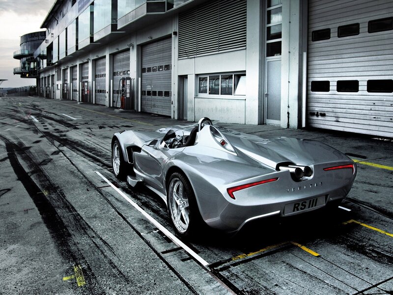 Silver sports car in pit lane
