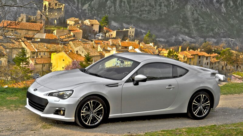 silver sports car in village