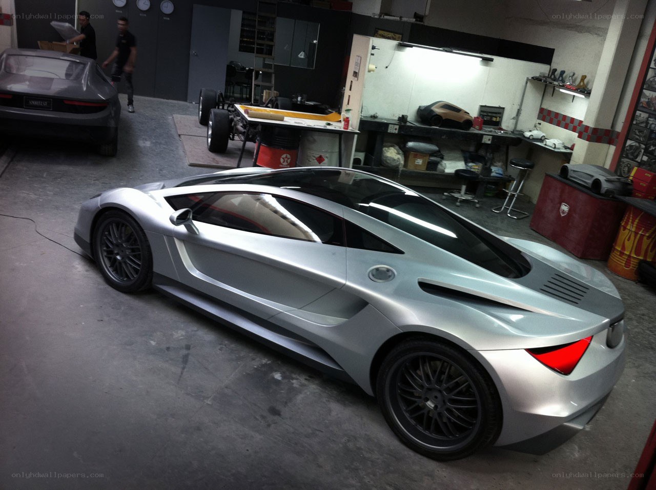 Silver sports car in workshop