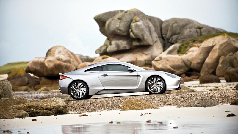 Silver sports car on a beach