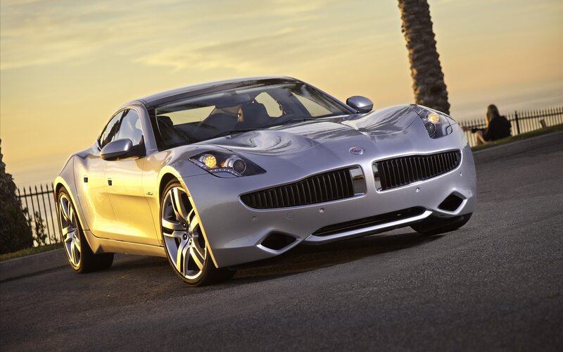 Silver sports car on a coastal road