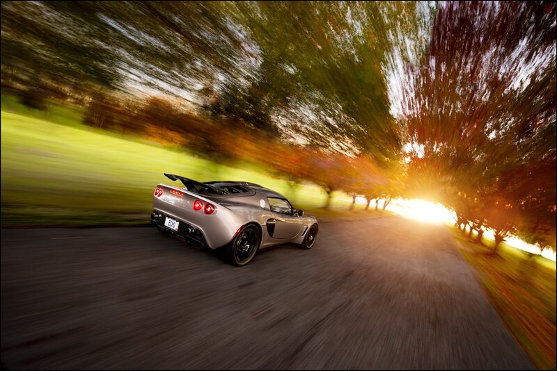 Silver sports car on a tree-lined road