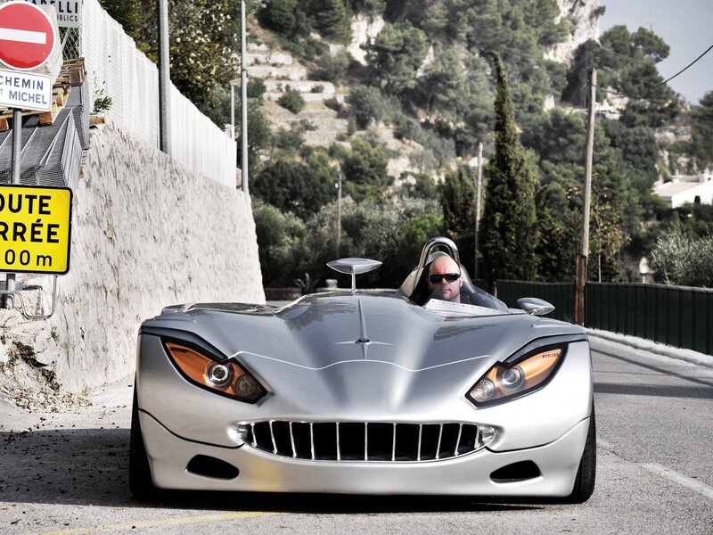 Silver sports car on a winding road