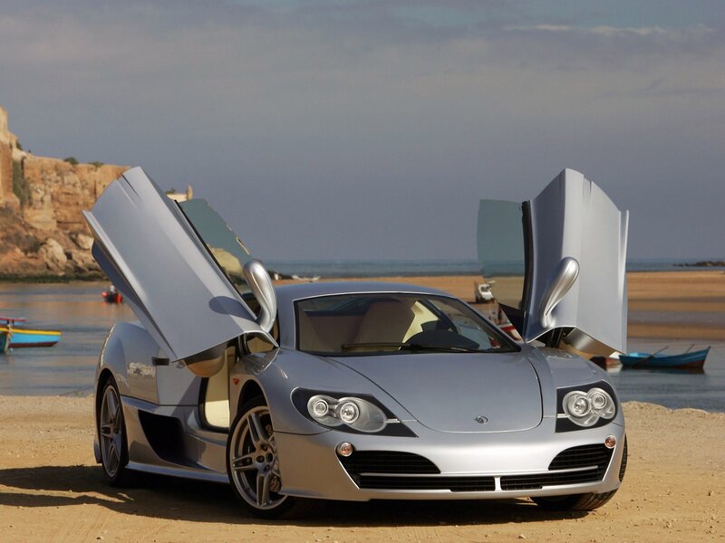 Silver sports car on beach