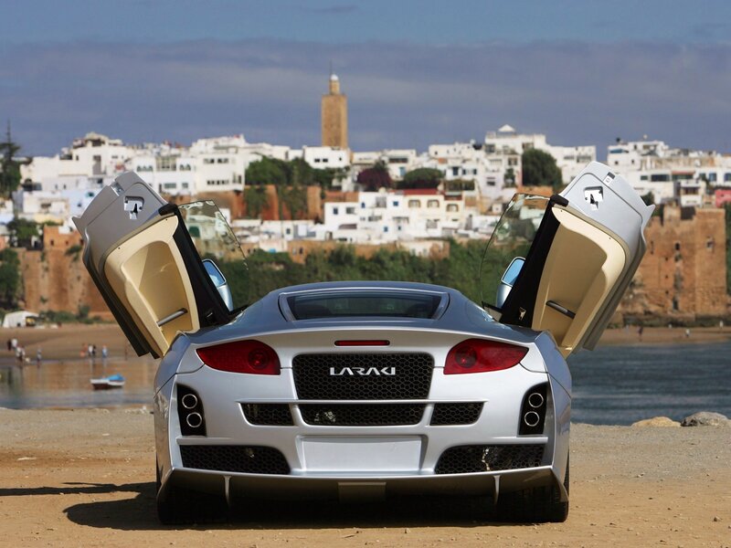 Silver sports car on beach