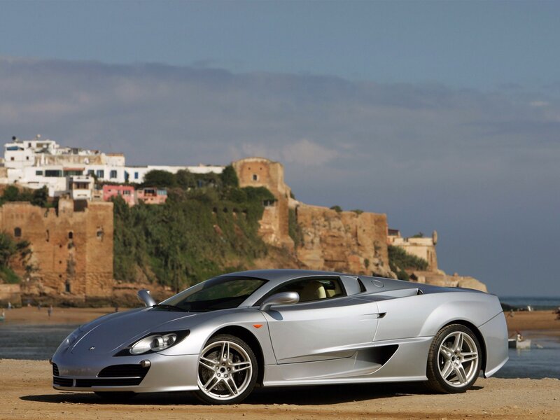 Silver sports car on beach