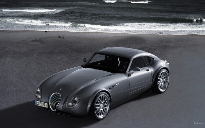 Silver sports car on beach