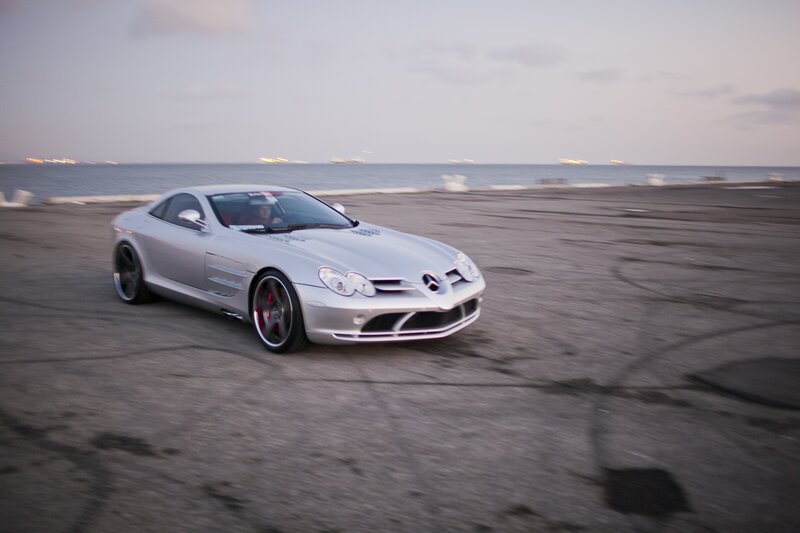 Silver sports car on beach