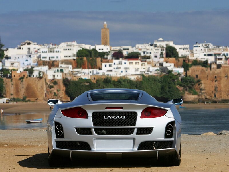 Silver sports car on beach