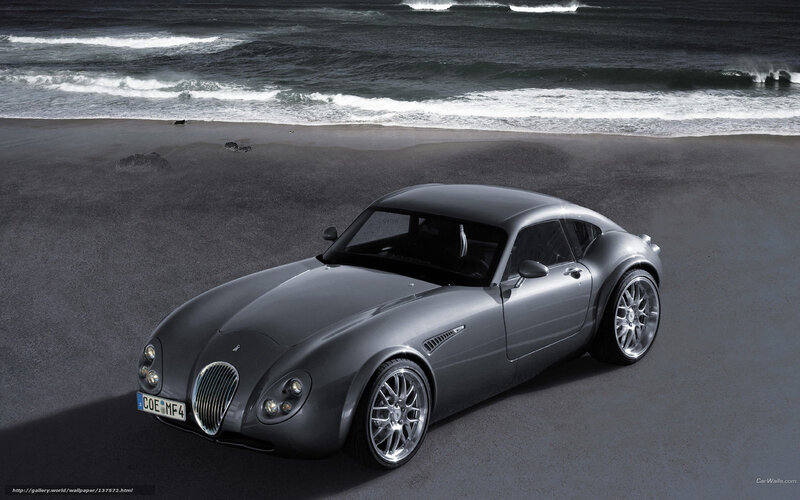 Silver sports car on beach