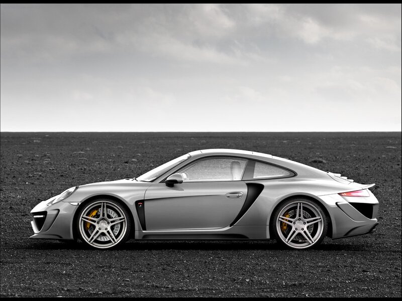 silver sports car on black sand