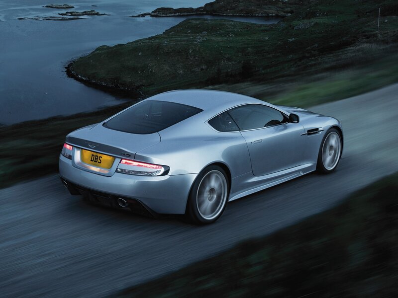 silver sports car on coastal road