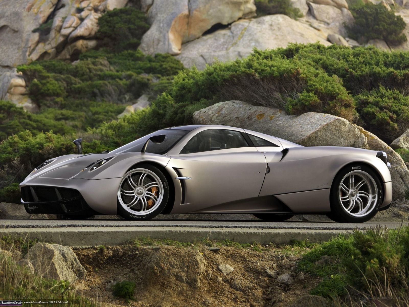 silver sports car on coastal road