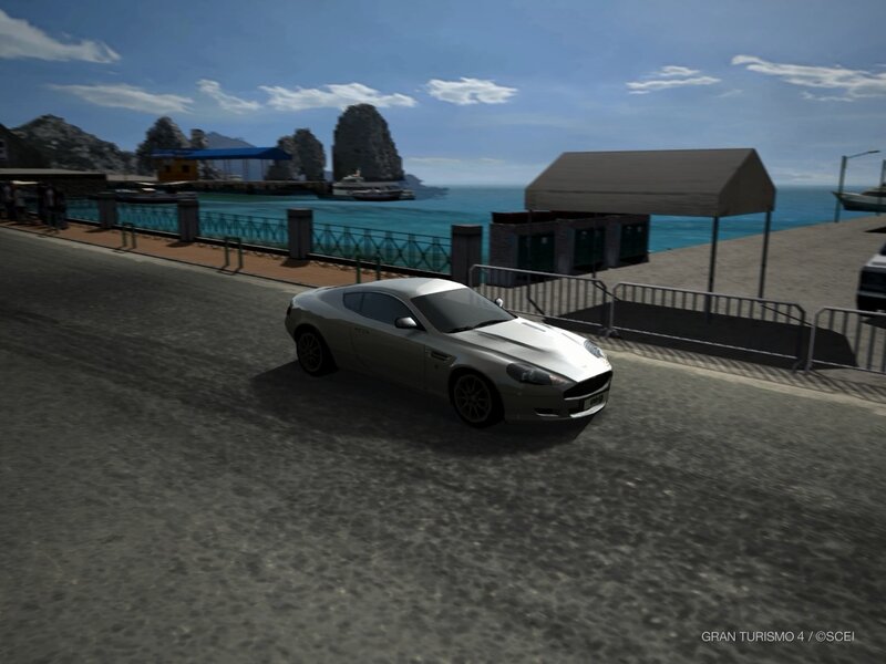 silver sports car on coastal road