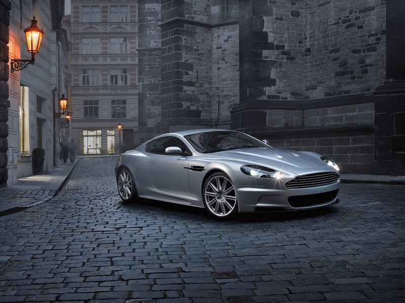 Silver sports car on cobblestone street