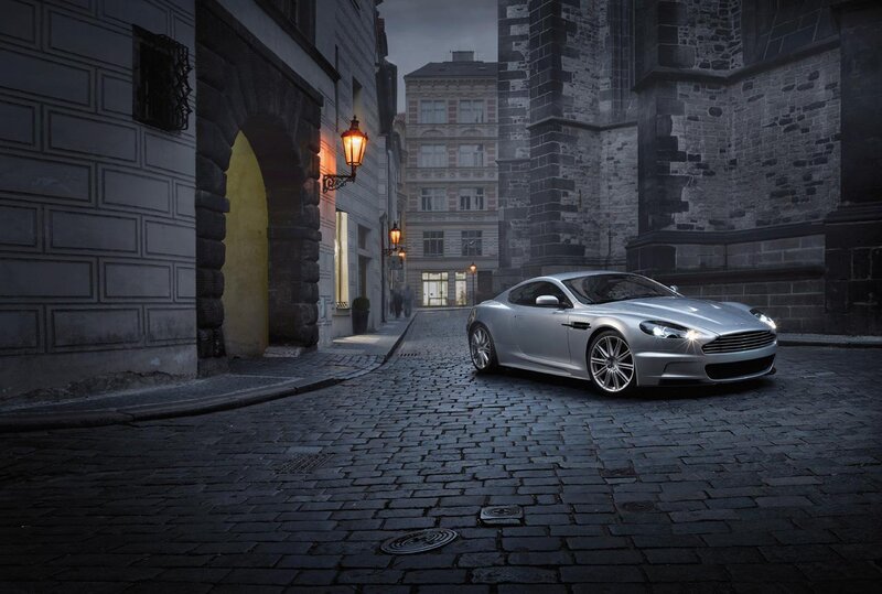 Silver sports car on cobblestone street