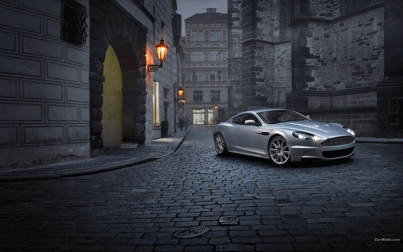 Silver sports car on cobblestone street