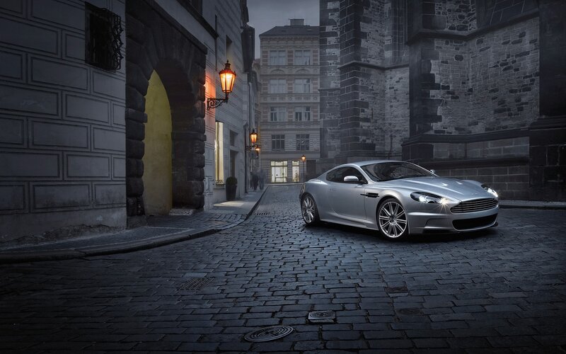 Silver sports car on cobblestone street