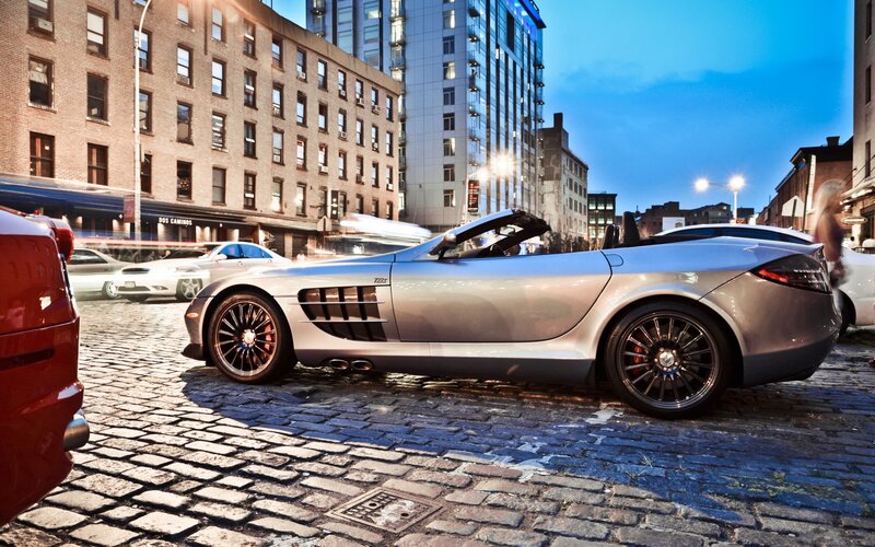 Silver sports car on cobblestone street
