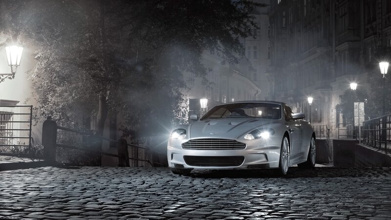Silver sports car on cobblestone street