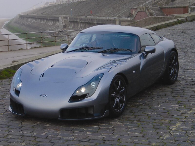 silver sports car on cobblestones