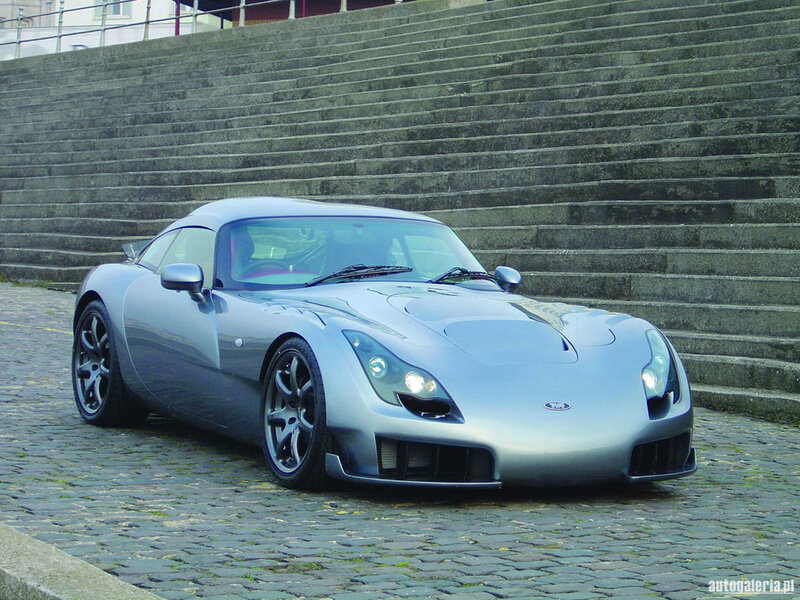 silver sports car on cobblestones