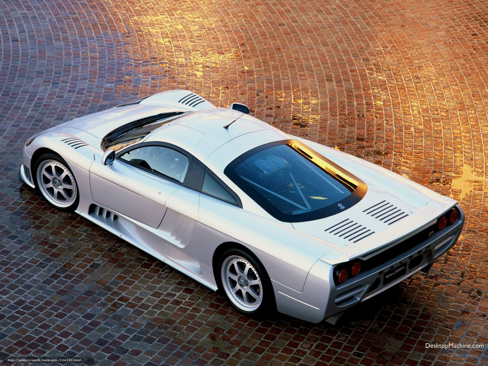 silver sports car on cobblestones