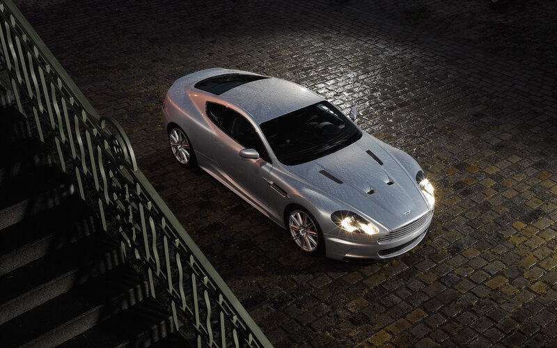 silver sports car on cobblestones