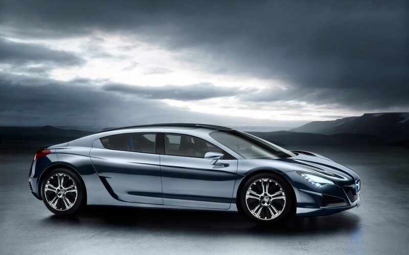 Silver sports car on dark landscape