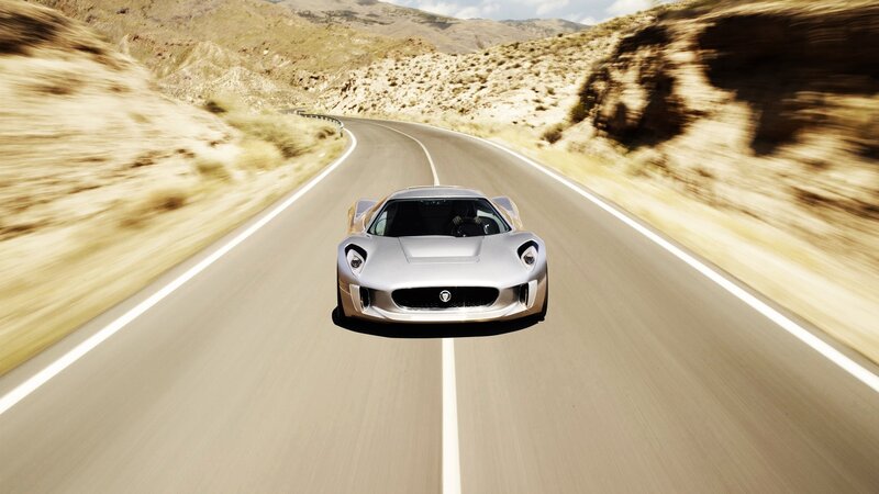 Silver sports car on desert road