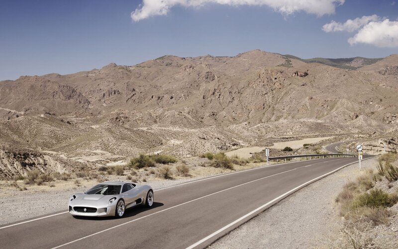 Silver sports car on desert road
