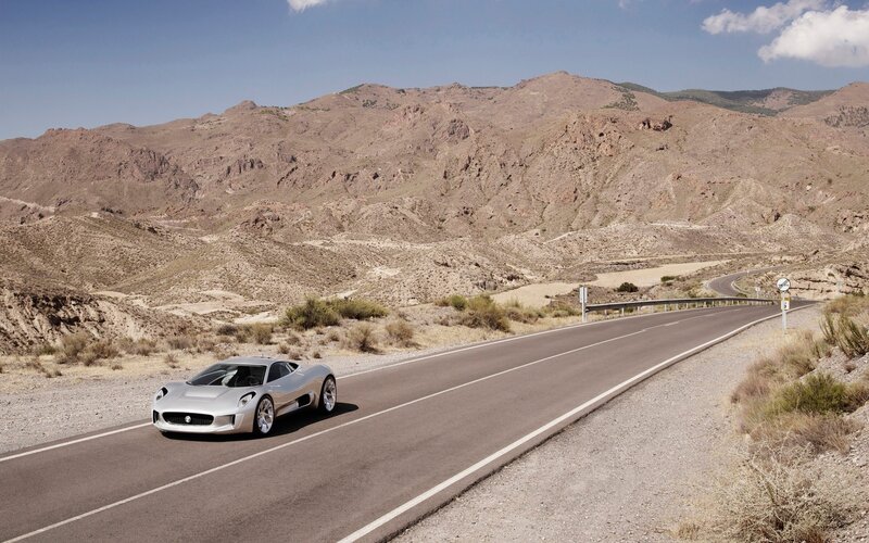 Silver sports car on desert road