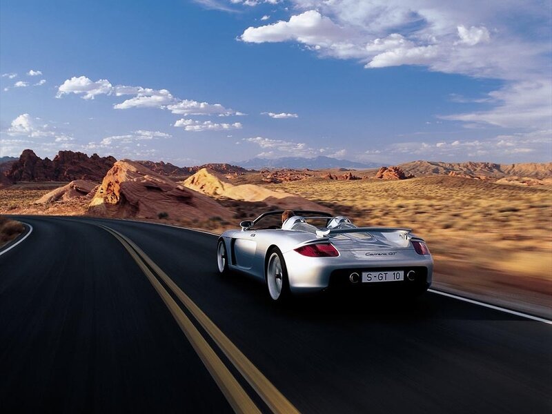 Silver sports car on desert road