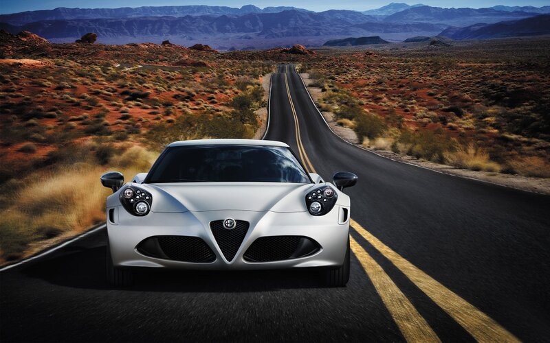 Silver sports car on desert road