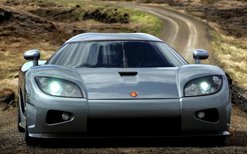 silver sports car on dirt road