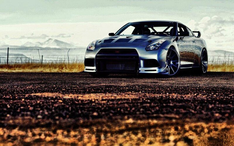 silver sports car on dirt road