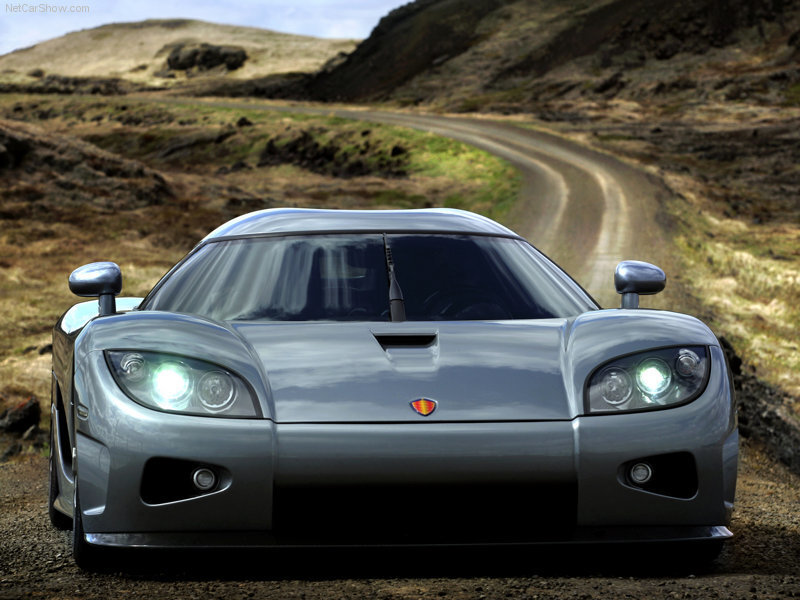 silver sports car on dirt road