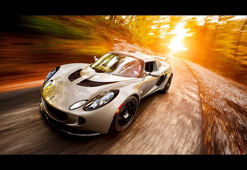 silver sports car on forest road
