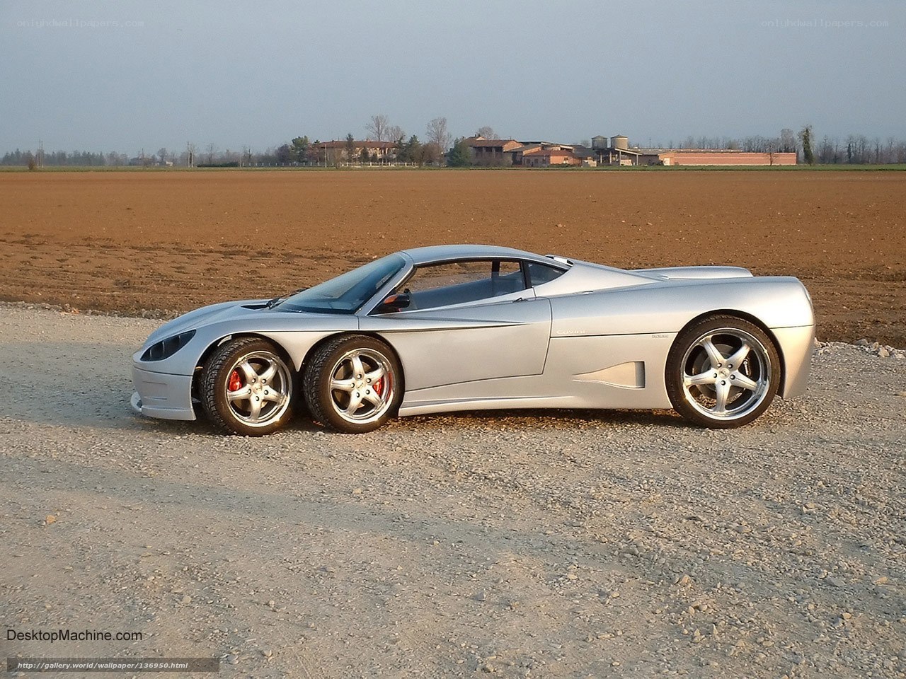Silver sports car on gravel