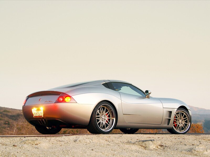 silver sports car on gravel