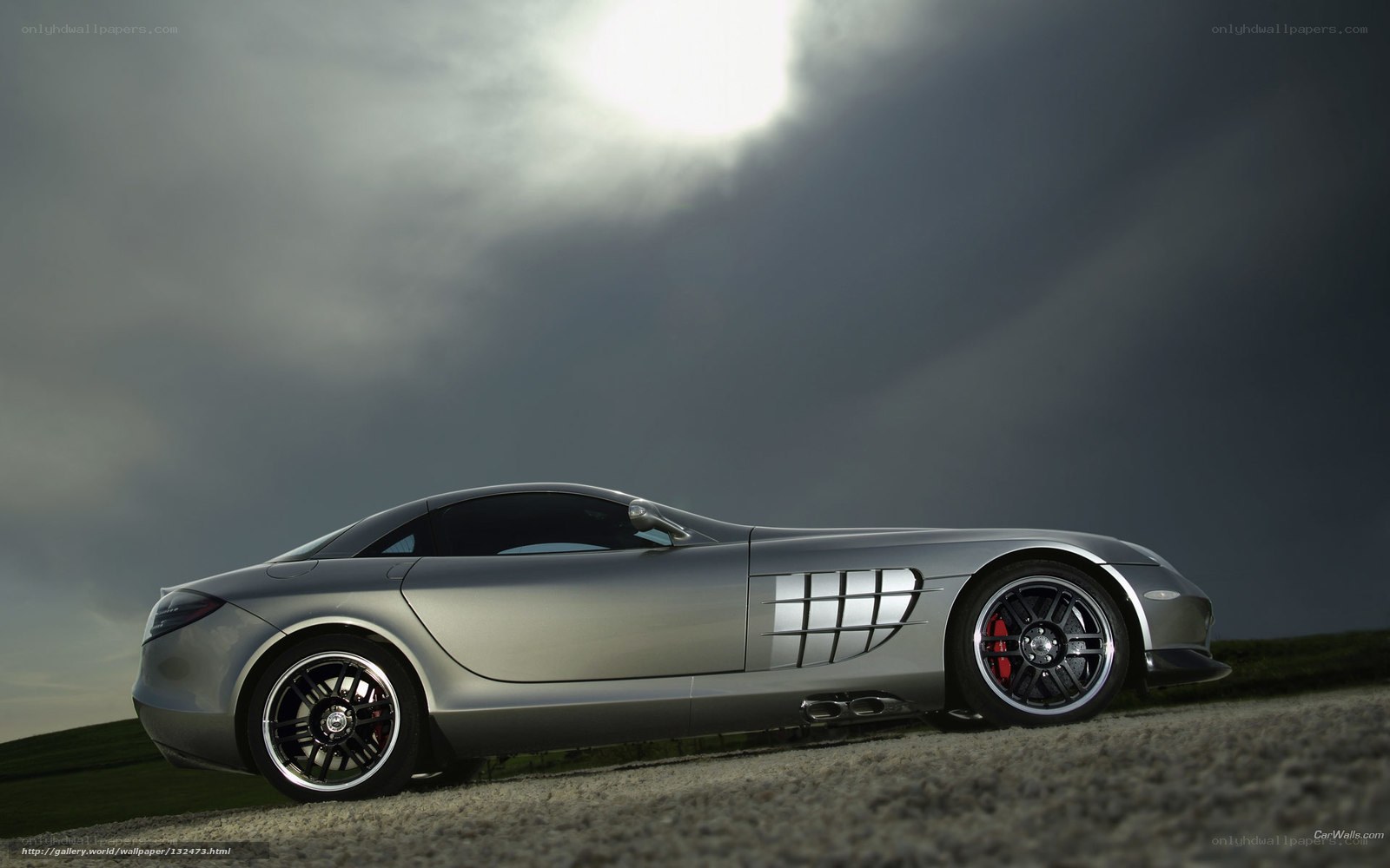 Silver sports car on gravel