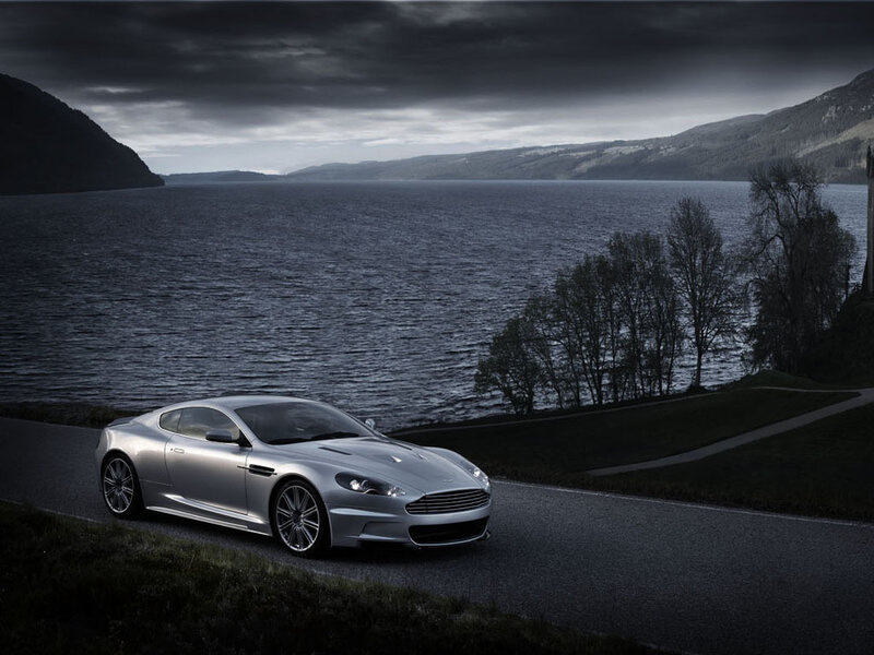 Silver sports car on lakeside road