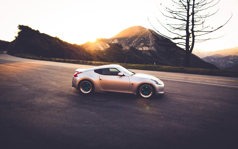 silver sports car on mountain road