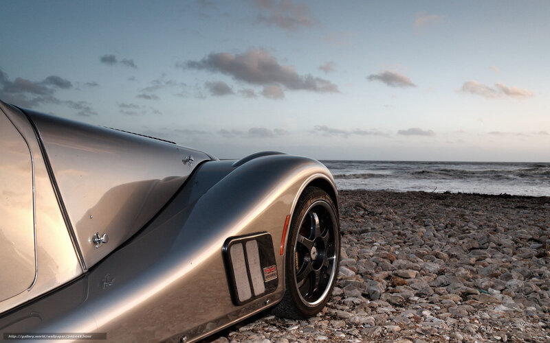 silver sports car on pebble beach