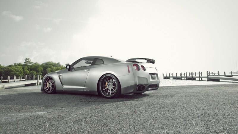 silver sports car on pier