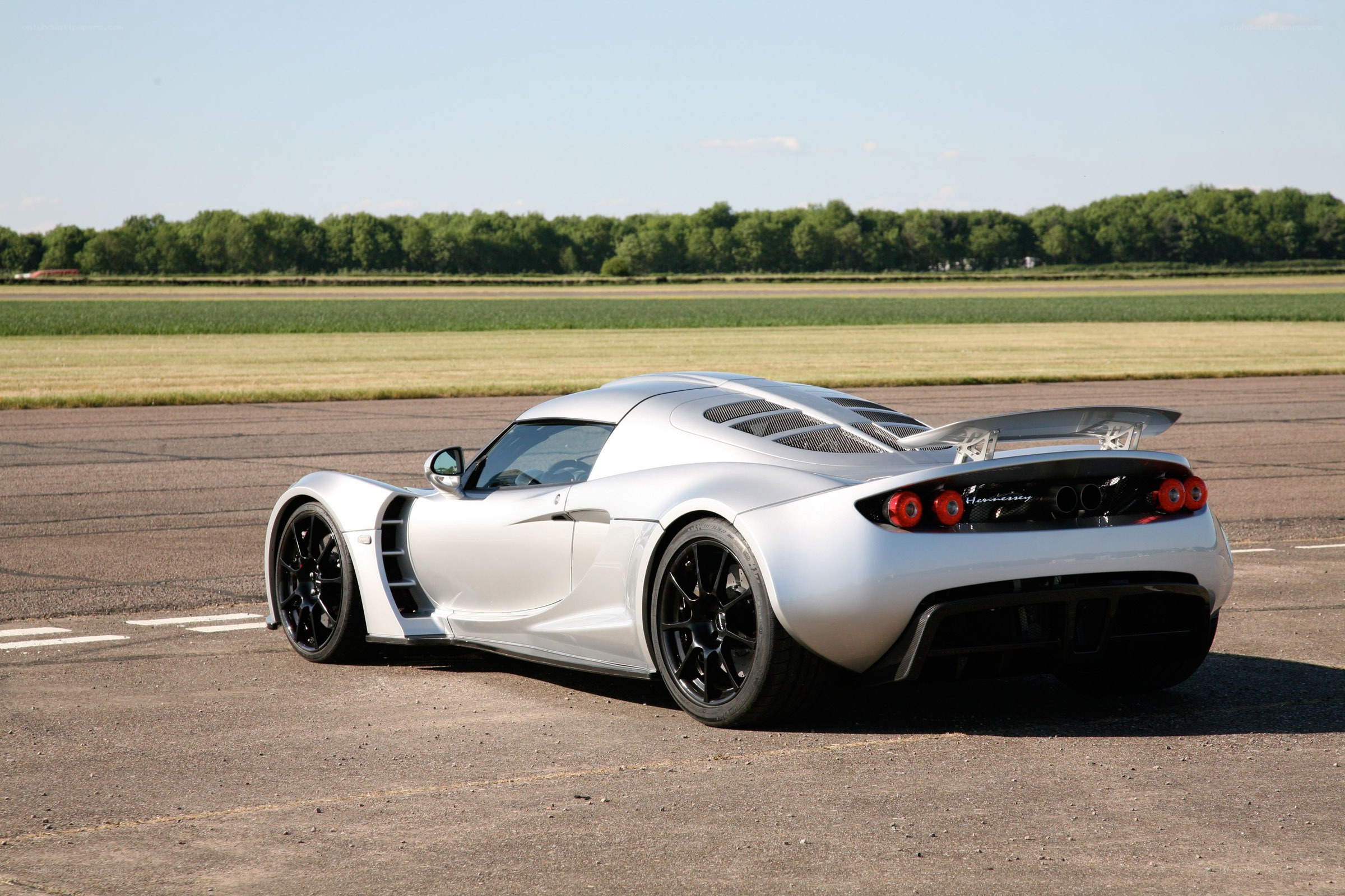 silver sports car on runway