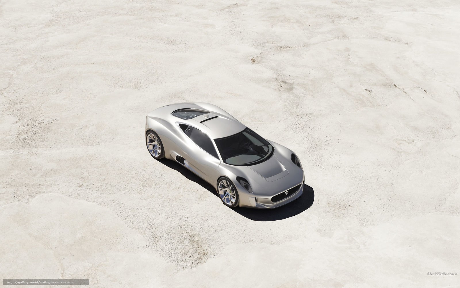 silver sports car on sand