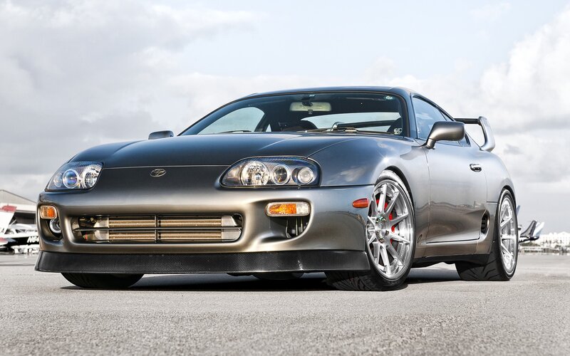 silver sports car on tarmac