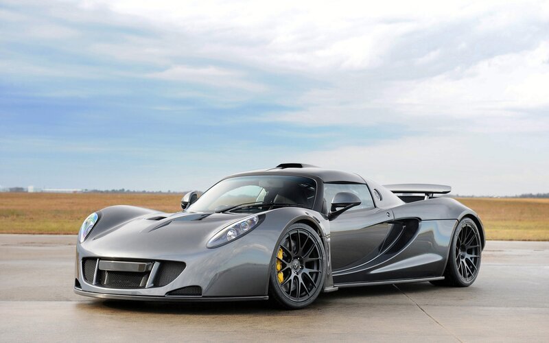 silver sports car on tarmac