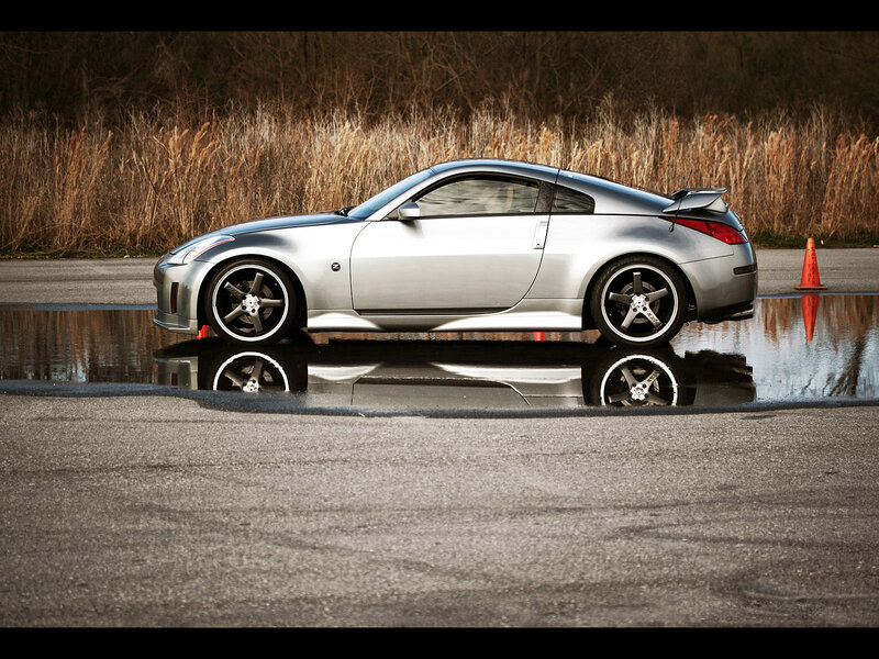silver sports car on wet pavement